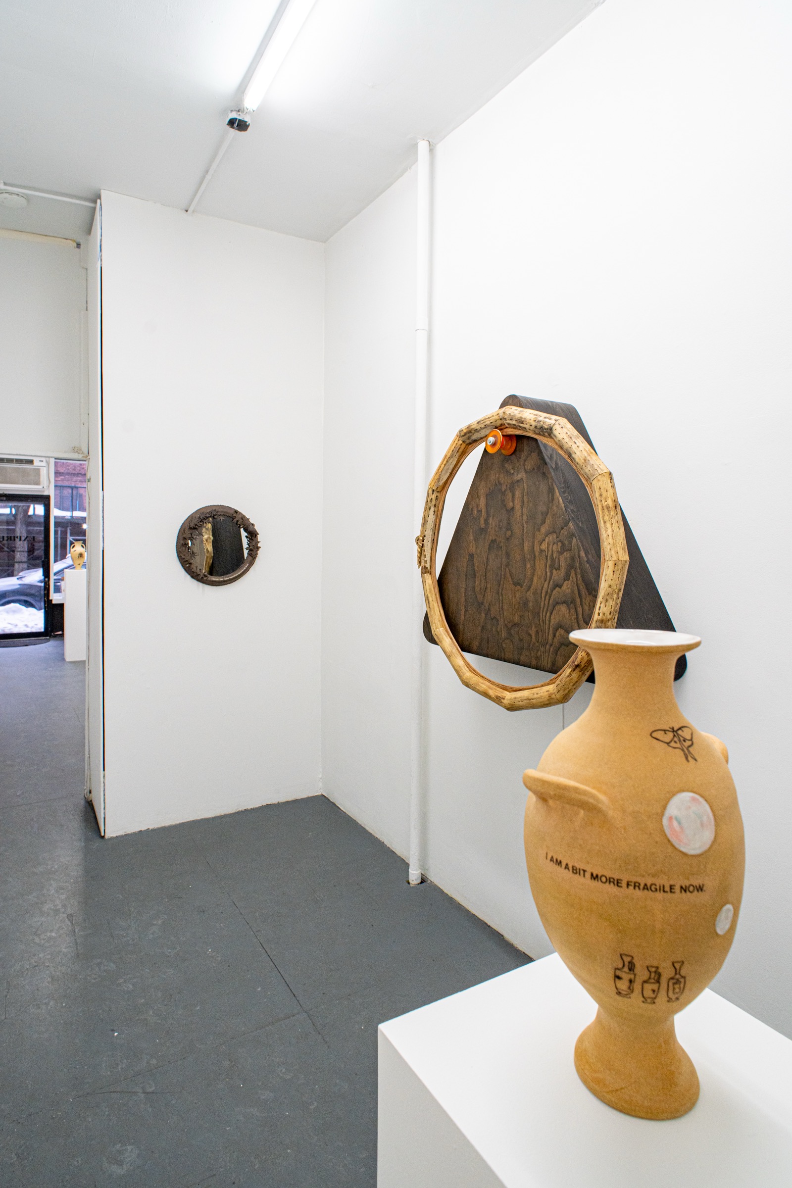 Ceramic vessels and wall works in the Expired exhibition