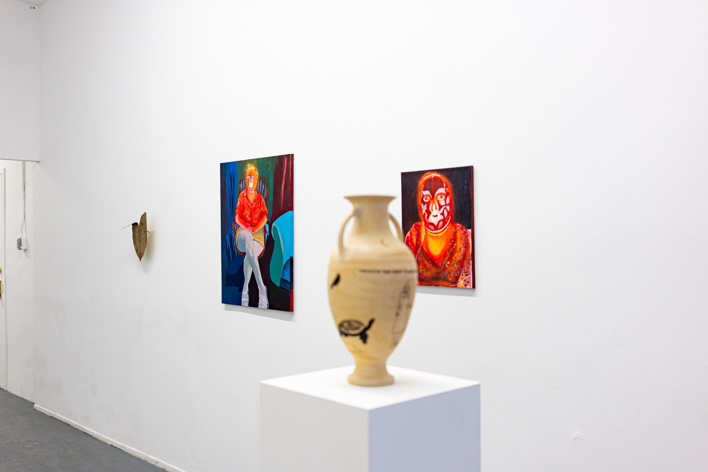 Expired installation view with a ceramic vessel and two paintings